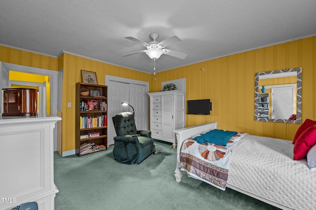 carpeted bedroom featuring ceiling fan, stainless steel fridge, crown molding, and a closet