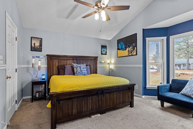 bedroom featuring ceiling fan, light colored carpet, lofted ceiling, and a textured ceiling