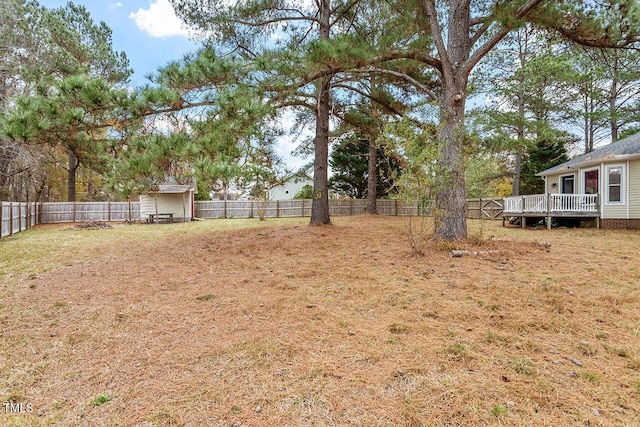 view of yard with a shed and a deck