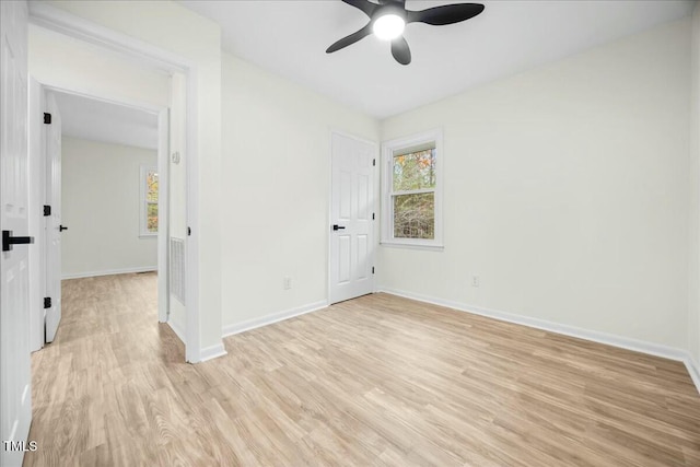 spare room with light wood-type flooring and ceiling fan