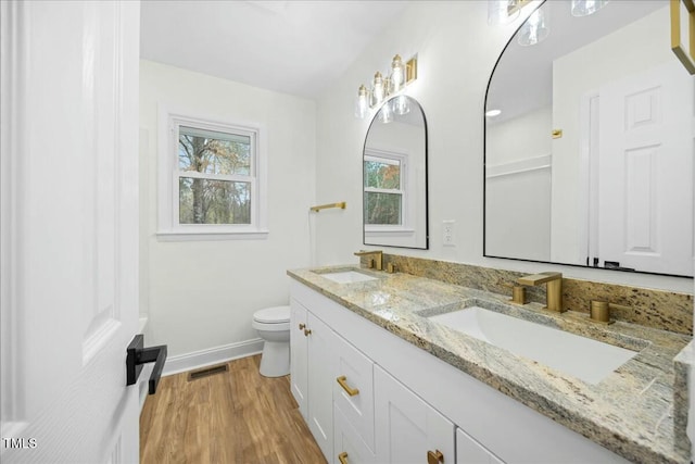 bathroom featuring hardwood / wood-style floors, vanity, and toilet