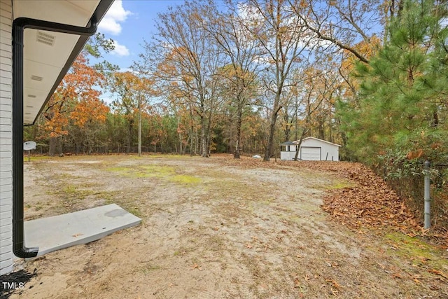 view of yard with an outbuilding and a garage