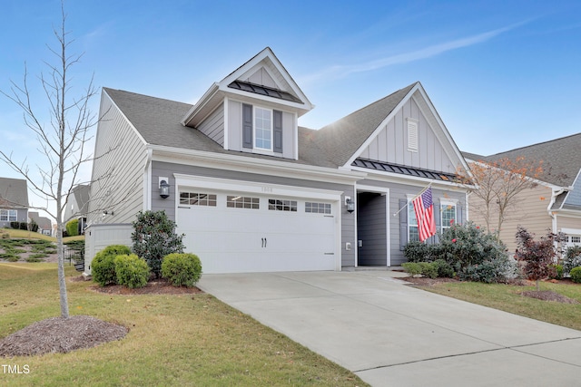 view of front of property featuring a garage and a front yard