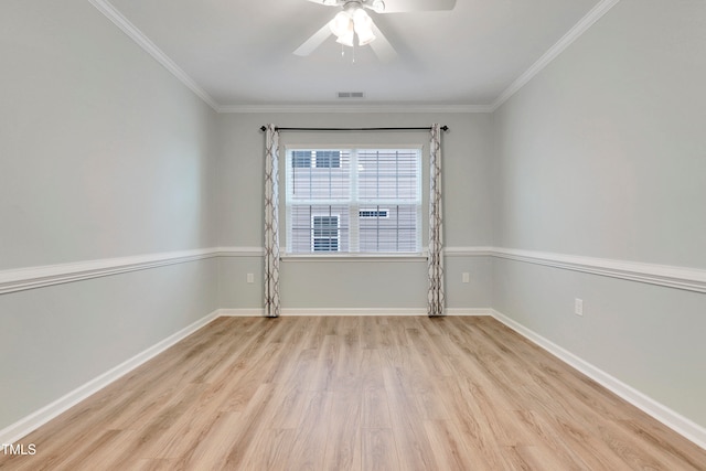 empty room featuring crown molding, light hardwood / wood-style flooring, and ceiling fan