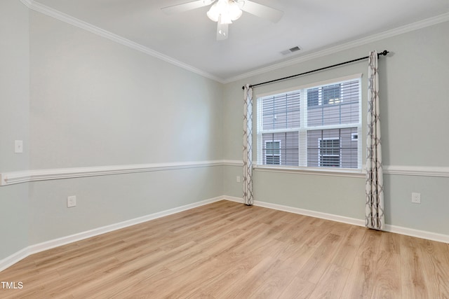 spare room with light wood-type flooring, ceiling fan, and ornamental molding