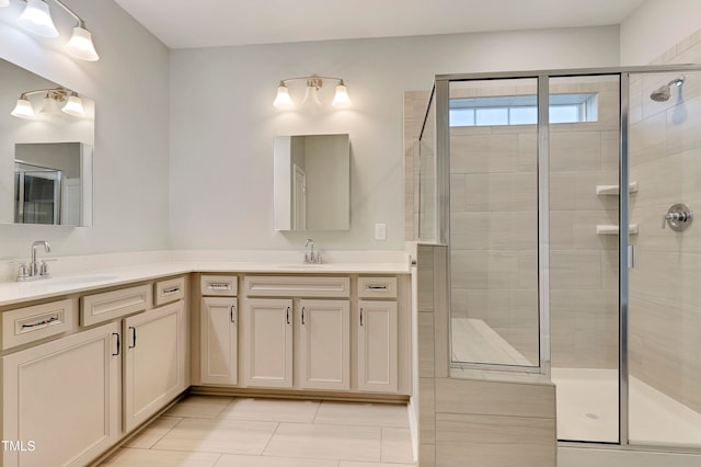 bathroom featuring tile patterned flooring, vanity, and walk in shower