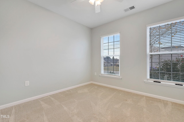 spare room featuring carpet flooring and ceiling fan