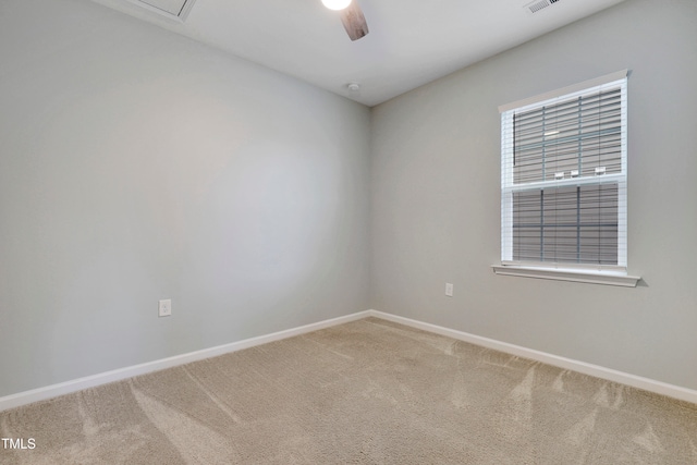 carpeted spare room with ceiling fan