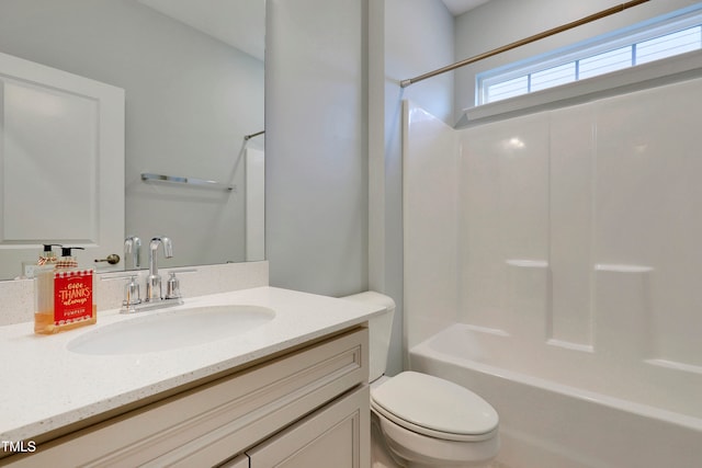 full bathroom with vanity, toilet, and washtub / shower combination