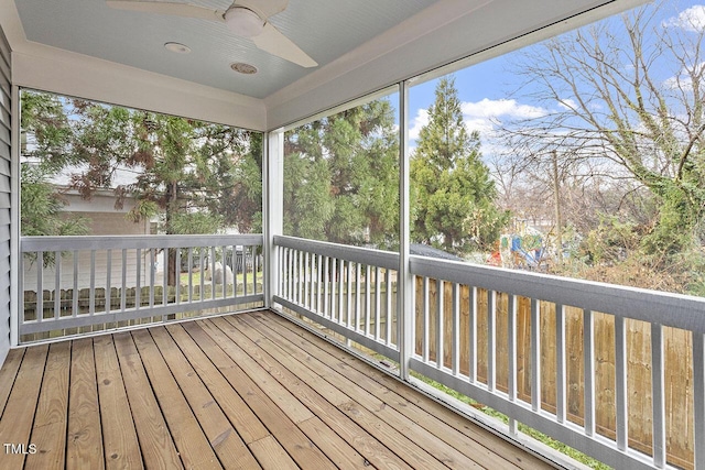 unfurnished sunroom featuring ceiling fan