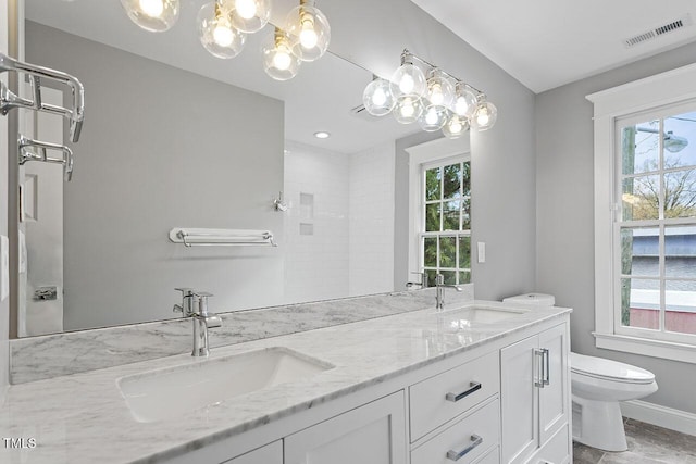 bathroom featuring vanity and toilet