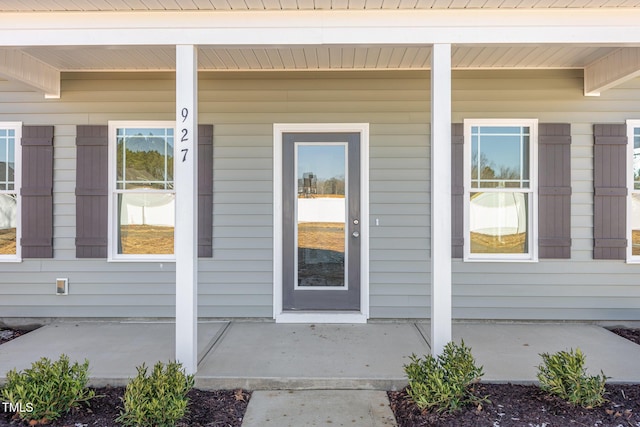 view of exterior entry featuring a porch