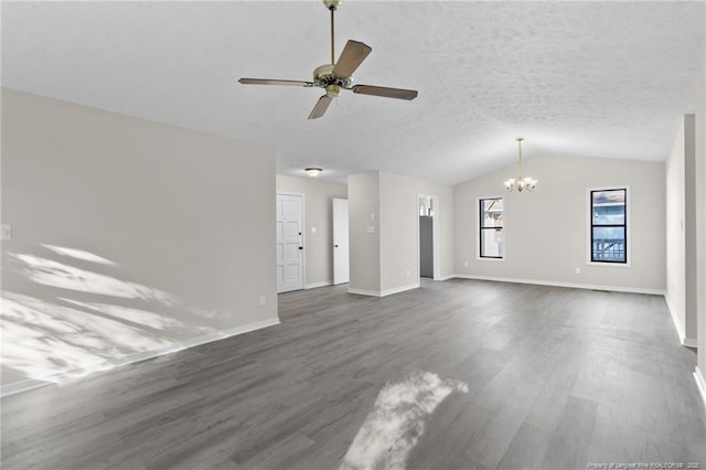 unfurnished living room featuring a textured ceiling, dark wood-type flooring, baseboards, and vaulted ceiling