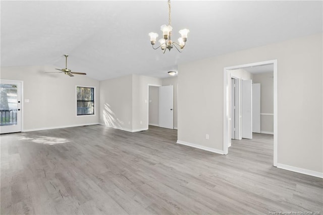 unfurnished living room featuring baseboards, lofted ceiling, wood finished floors, and ceiling fan with notable chandelier