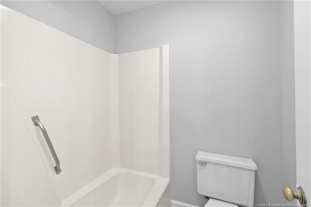 bathroom with shower / bathing tub combination and toilet