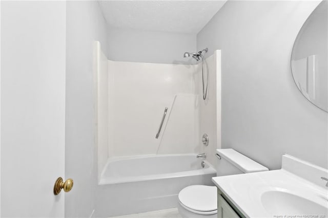 bathroom with toilet, vanity, a textured ceiling, and shower / tub combination