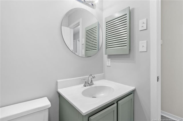 bathroom featuring toilet and vanity