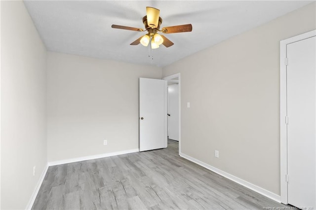 unfurnished room featuring a ceiling fan, baseboards, and wood finished floors