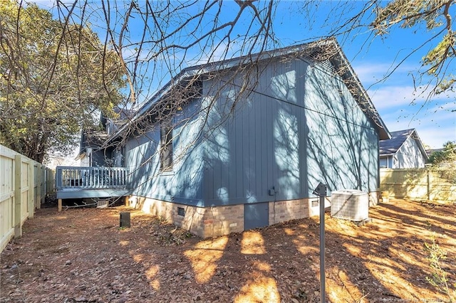 view of home's exterior with crawl space, a deck, and a fenced backyard