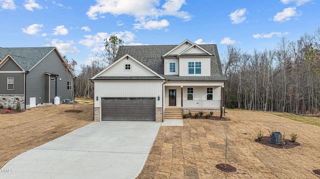 view of front facade featuring covered porch, a garage, and a front lawn