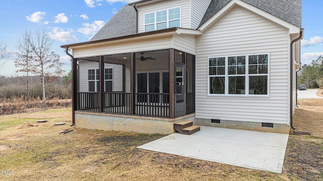 rear view of house with a sunroom and a patio