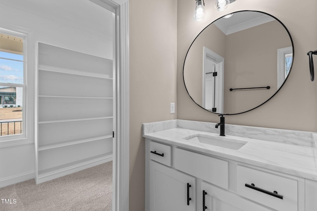 bathroom featuring crown molding and vanity