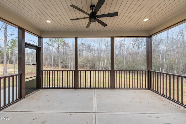 unfurnished sunroom with ceiling fan and plenty of natural light