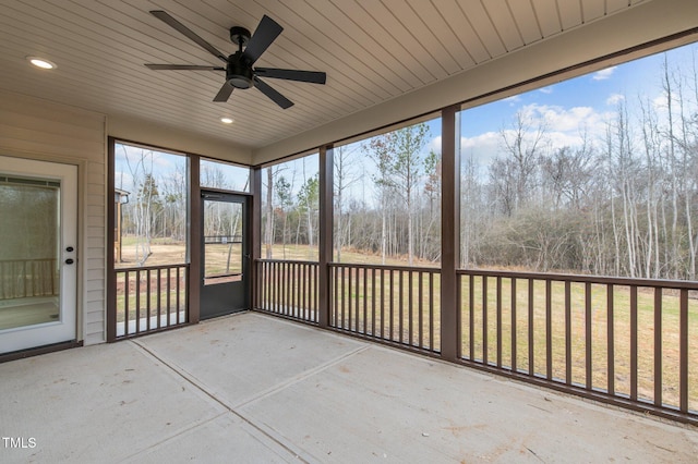 unfurnished sunroom with ceiling fan