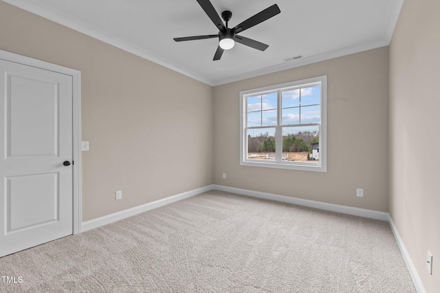 carpeted spare room featuring ceiling fan and crown molding