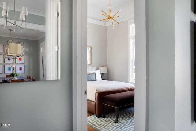 bedroom with ornamental molding and an inviting chandelier