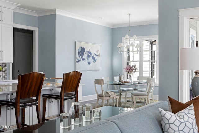 dining room with ornamental molding and a chandelier