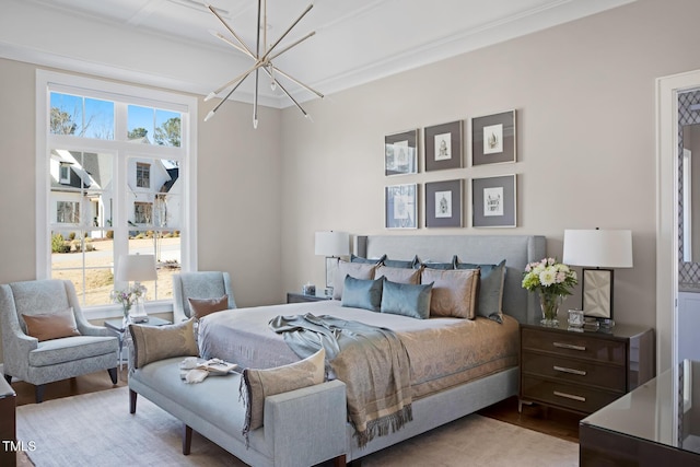 bedroom with light hardwood / wood-style floors and a chandelier