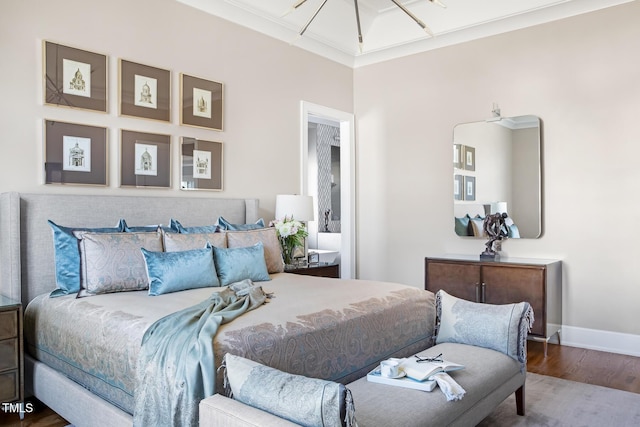 bedroom featuring wood-type flooring and crown molding