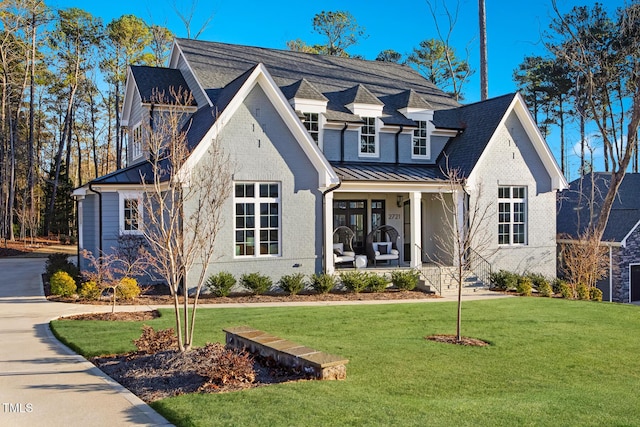 view of front of property with a porch and a front lawn