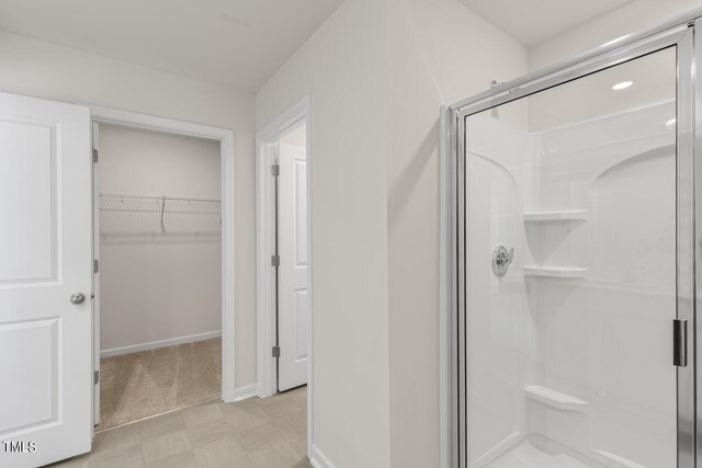 bathroom featuring a shower with shower door