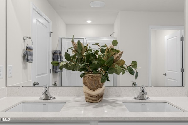 bathroom with vanity and a shower with shower door