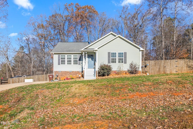 ranch-style home featuring a front yard