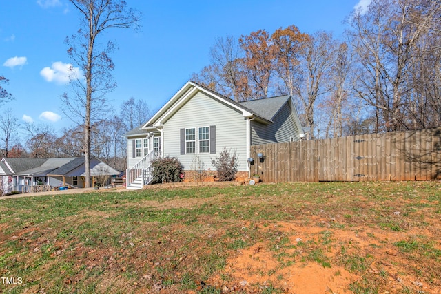 view of property exterior featuring a lawn