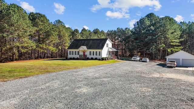 view of front of home featuring a front lawn, an outdoor structure, and a garage