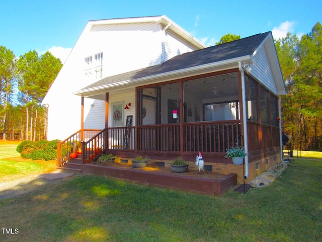 view of front of house with a sunroom and a front lawn