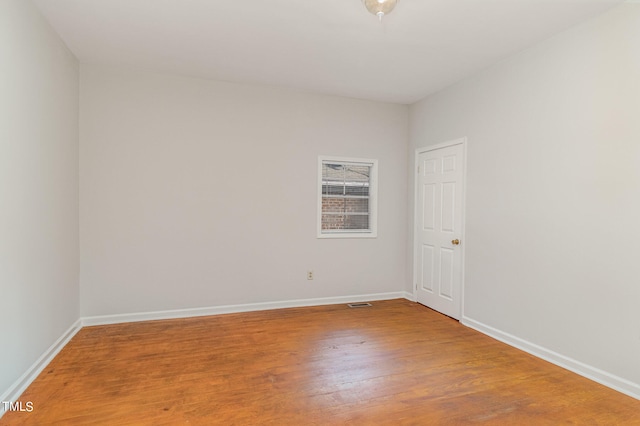 empty room with hardwood / wood-style flooring