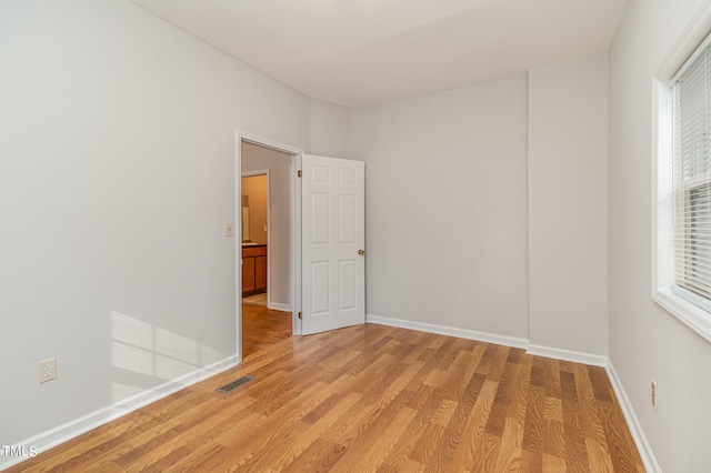 spare room featuring light hardwood / wood-style flooring