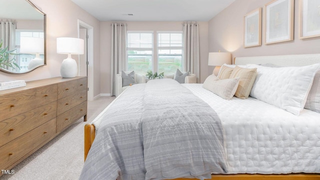 carpeted bedroom featuring multiple windows