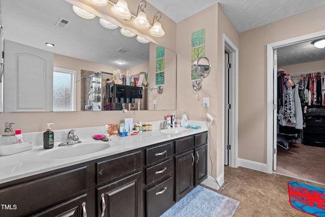 bathroom featuring tile patterned floors, vanity, and an enclosed shower