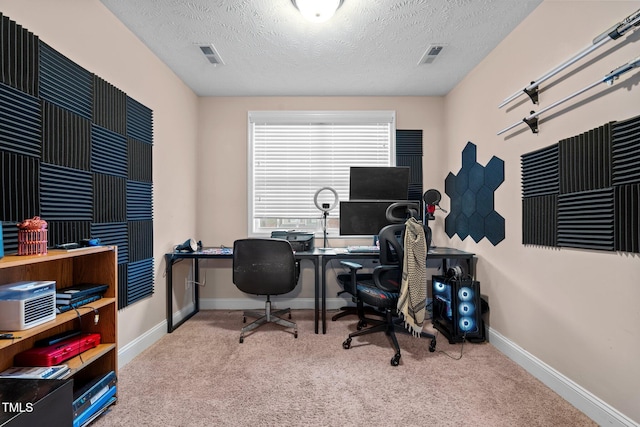 home office featuring a textured ceiling and light colored carpet