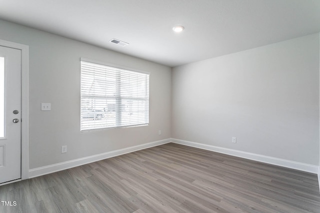 empty room with hardwood / wood-style floors