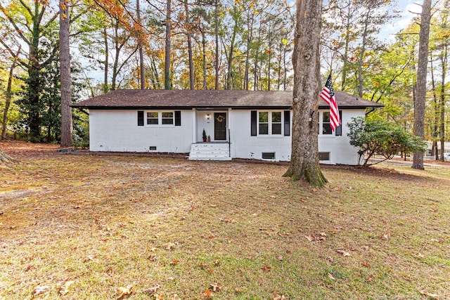 ranch-style home with a front lawn