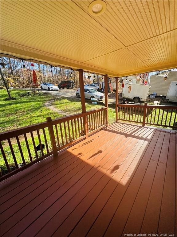 wooden terrace with a yard