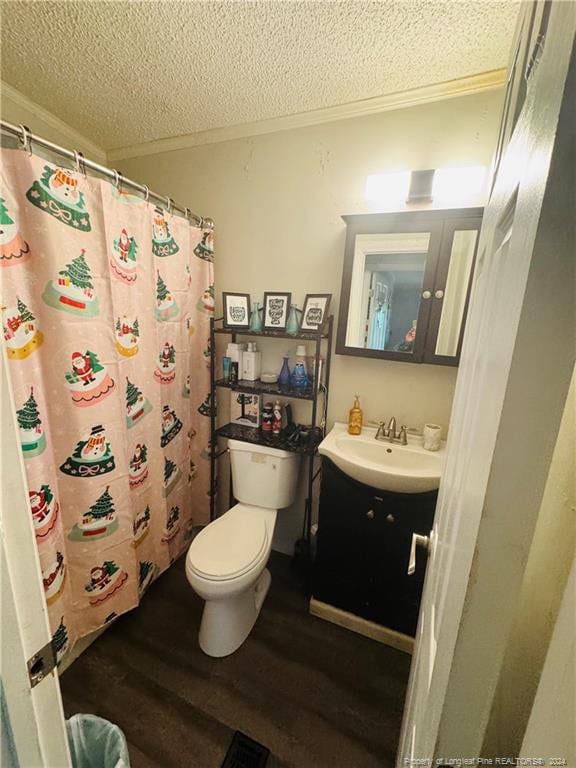 bathroom with vanity, hardwood / wood-style flooring, a shower with shower curtain, toilet, and a textured ceiling