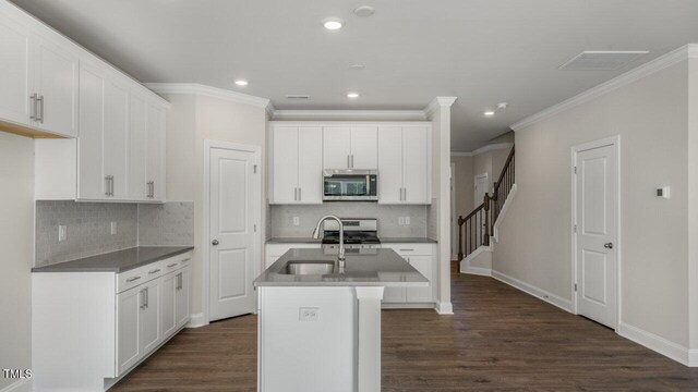 1825 Hinesley Dr, Durham, NC 27703 - kitchen featuring stainless steel appliances, crown molding, dark wood-style floors, backsplash, and recessed lighting